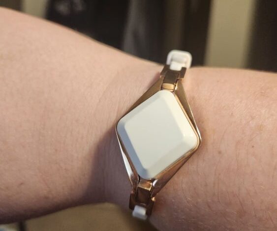 white diamond-shaped fitness tracker bracelet on wrist