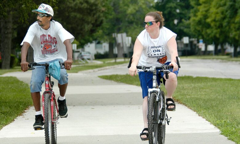 A photo of a man and woman riding bicycles together.