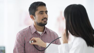 doctor using stethoscope on patient