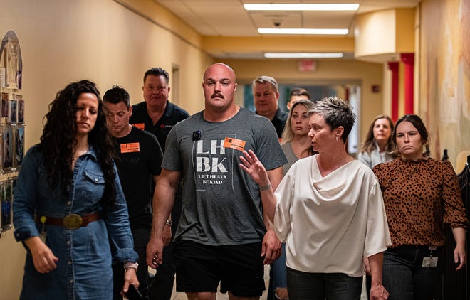 Julie Spry, Vice President of Development, right, talks with Mitchell Hooper, winner of the 2023 World's Strongest Man competition, as he toured the Home of the Innocents during a stop in Louisville on Tuesday, June 20, 2023.