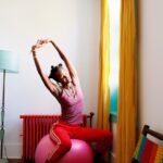 Woman stretching on exercise ball.
