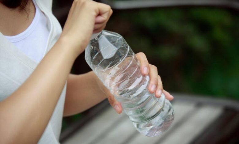 &lt;p&gt;RunPhoto/Getty&lt;/p&gt; A woman opening a bottle of water