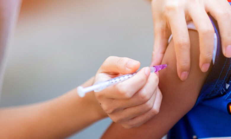 Child receiving a vaccination shot in the arm