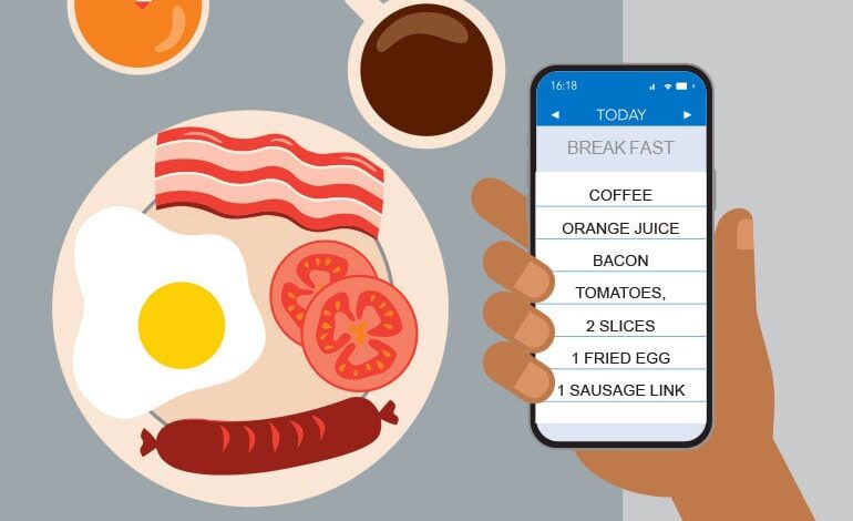 Person recording breakfast details on smartphone for food journal.