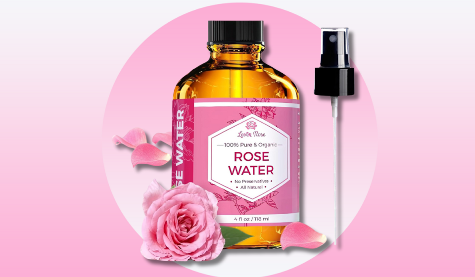 bottle of rose water with spray pump and pink roses