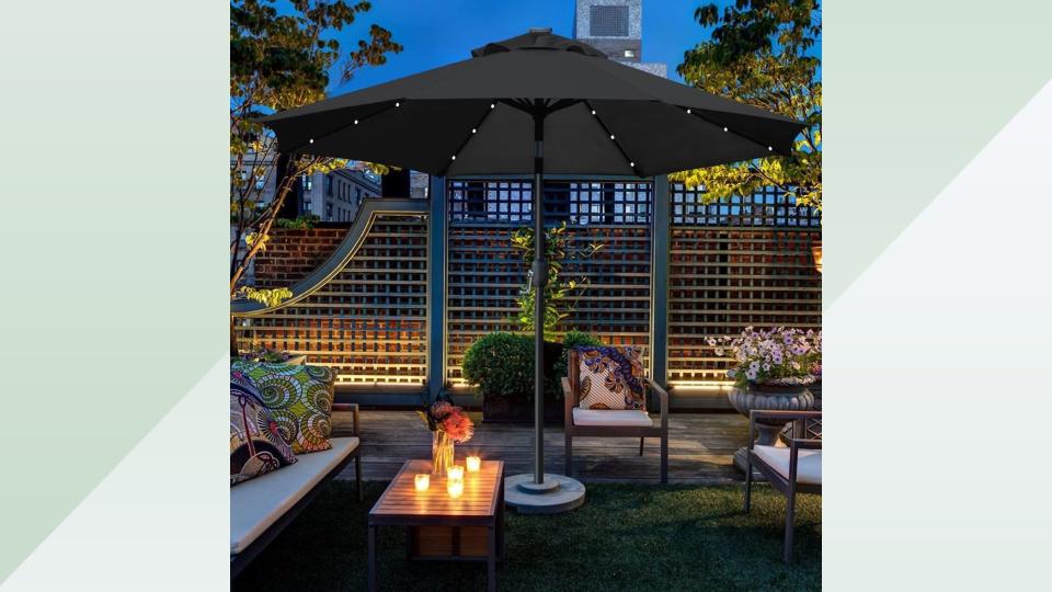 Patio at night with the lighted patio umbrella. 