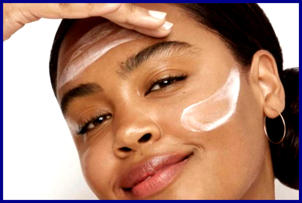 A young woman trying Olay night cream on her forehead and face.