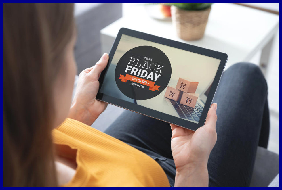 Woman looking at Black Friday imagery on an iPad